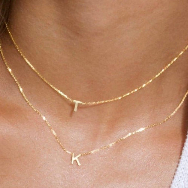 14K solid gold initial necklaces in yellow gold on model, available in rose gold and white gold
