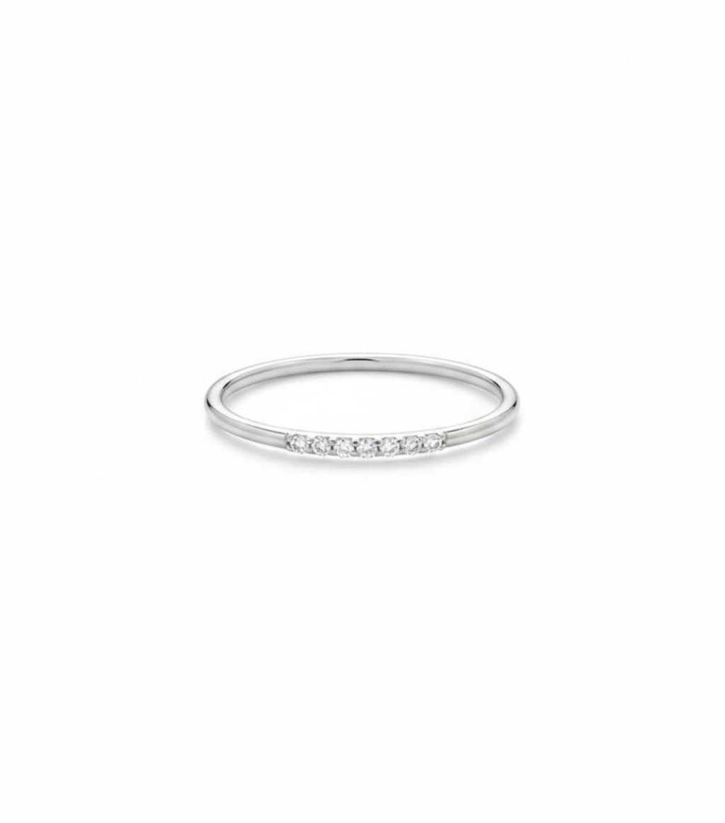 Dainty gold diamond stack ring, showing the slim band and delicate row of diamonds, white gold
