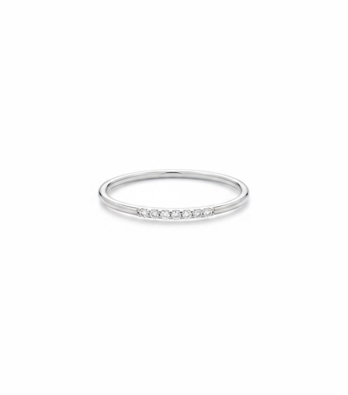 Dainty gold diamond stack ring, showing the slim band and delicate row of diamonds, white gold
