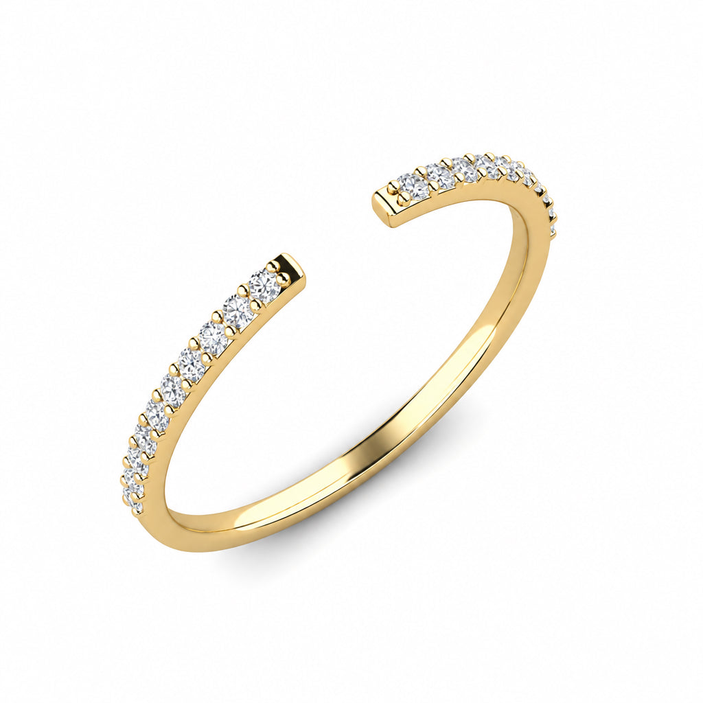 Yellow gold open stack ring with white pavé diamonds, shown at an angle.
