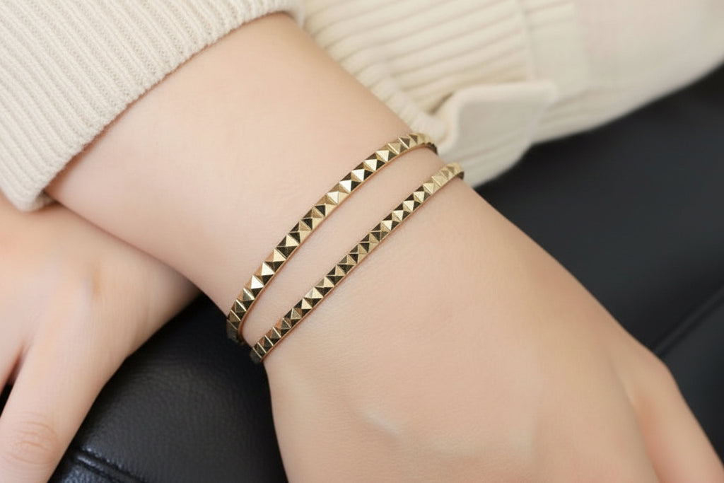 14k solid gold pyramid bracelet stacked on wrist, geometric pyramid studs in yellow gold
