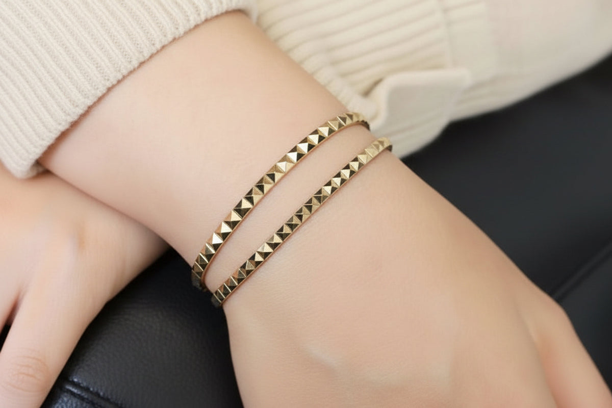 14k solid gold pyramid bracelet stacked on wrist, geometric pyramid studs in yellow gold
