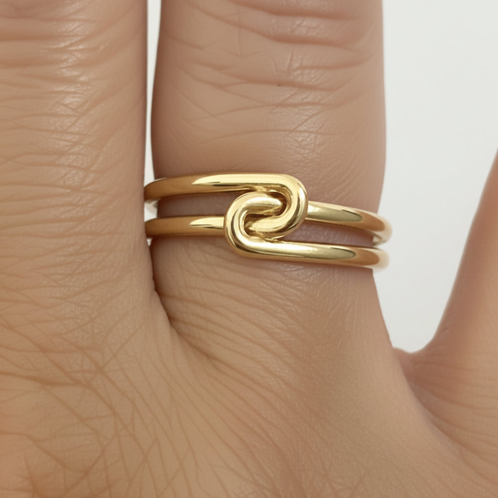 14k solid gold knot double ring - sculptural infinity knot double band, yellow gold closeup on model hand

