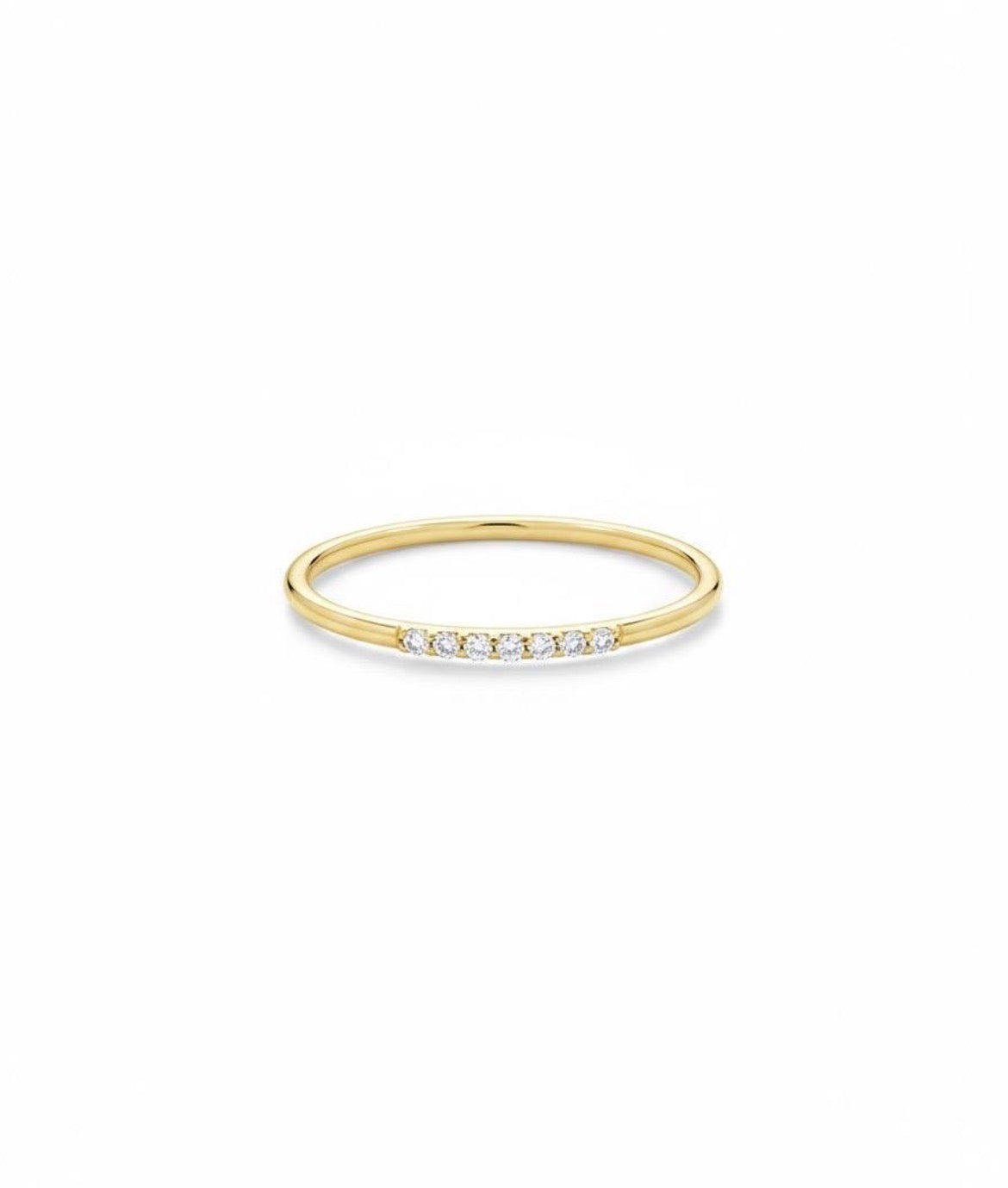 Dainty yellow gold diamond stack ring, showing the slim band and delicate row of diamonds
