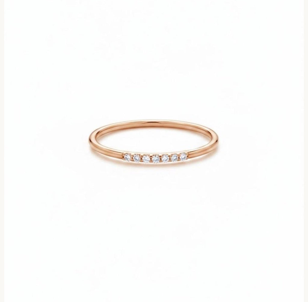 Dainty rose gold diamond stack ring, showing the slim band and delicate row of diamonds.
