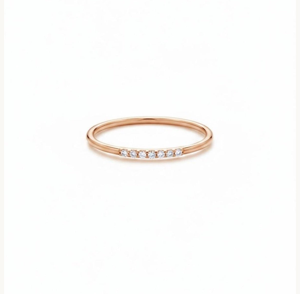 Dainty rose gold diamond stack ring, showing the slim band and delicate row of diamonds.
